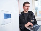 Employee checks heating data on laptop